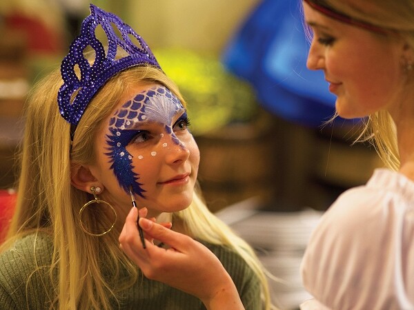 young girl enjoys mermaid makeover