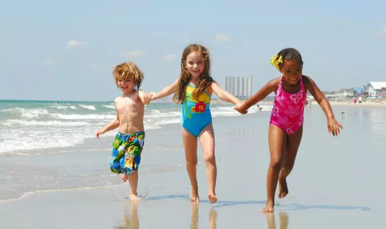 Children running on beach in SC