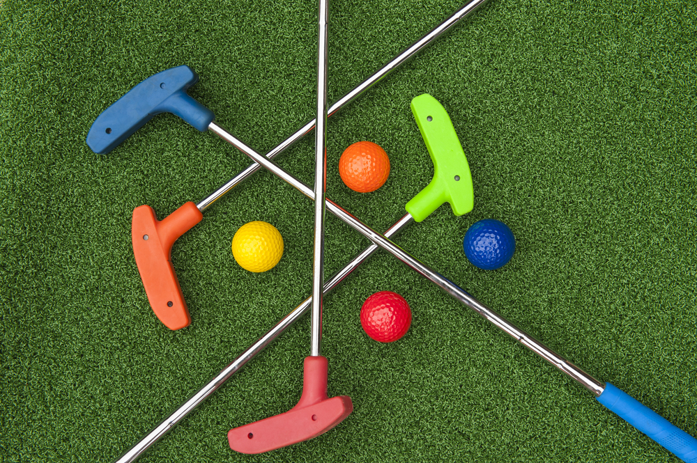 mini golf clubs and colorful golf balls